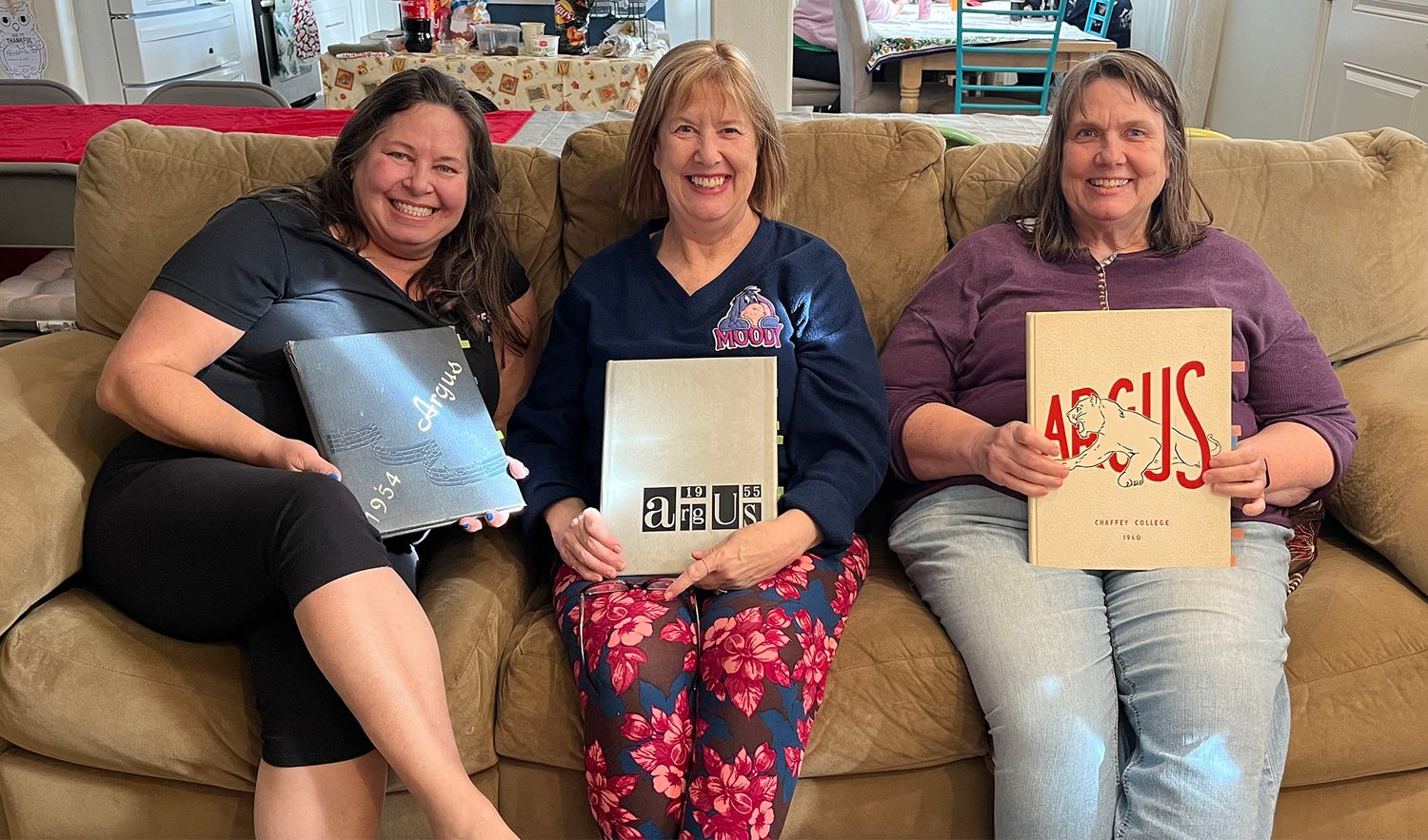 3 sisters enjoying yearbooks of their parents