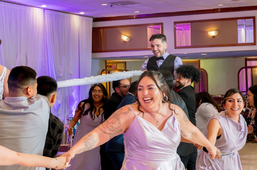 Wedding guests dancing and celebrating on a dance floor. Dynamic wedding photos Chicago