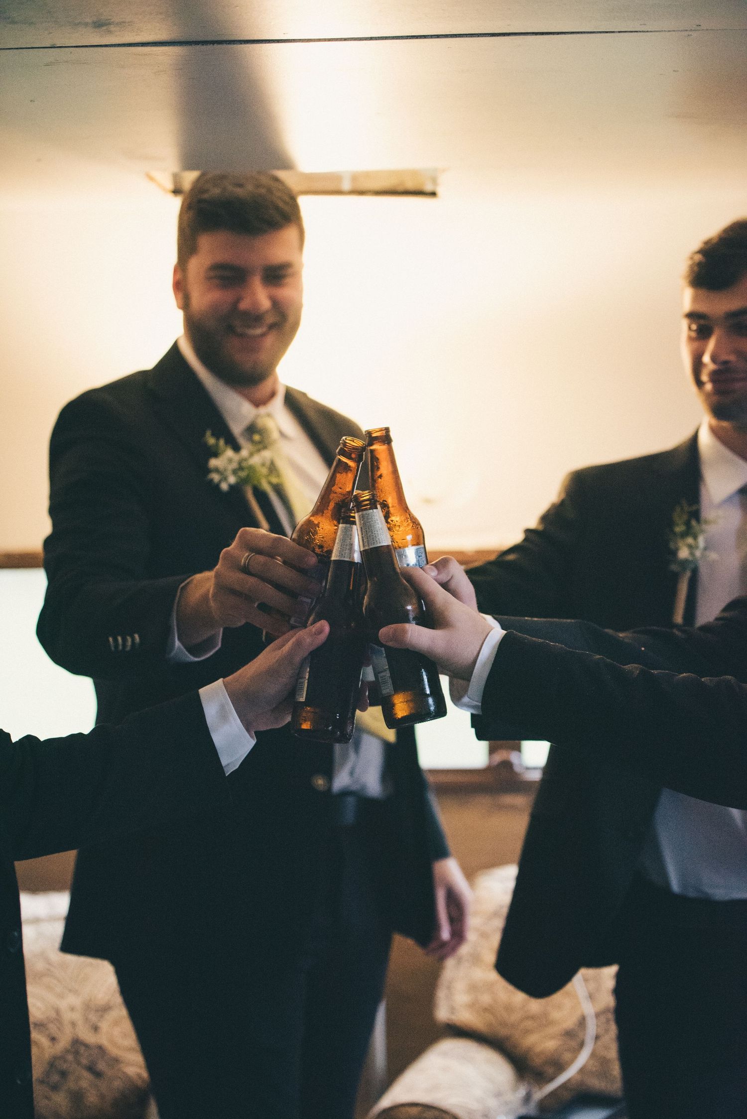 The groom and his groomsmen share a beer before the groom heads off to share a private moment with his bride before the ceremony.