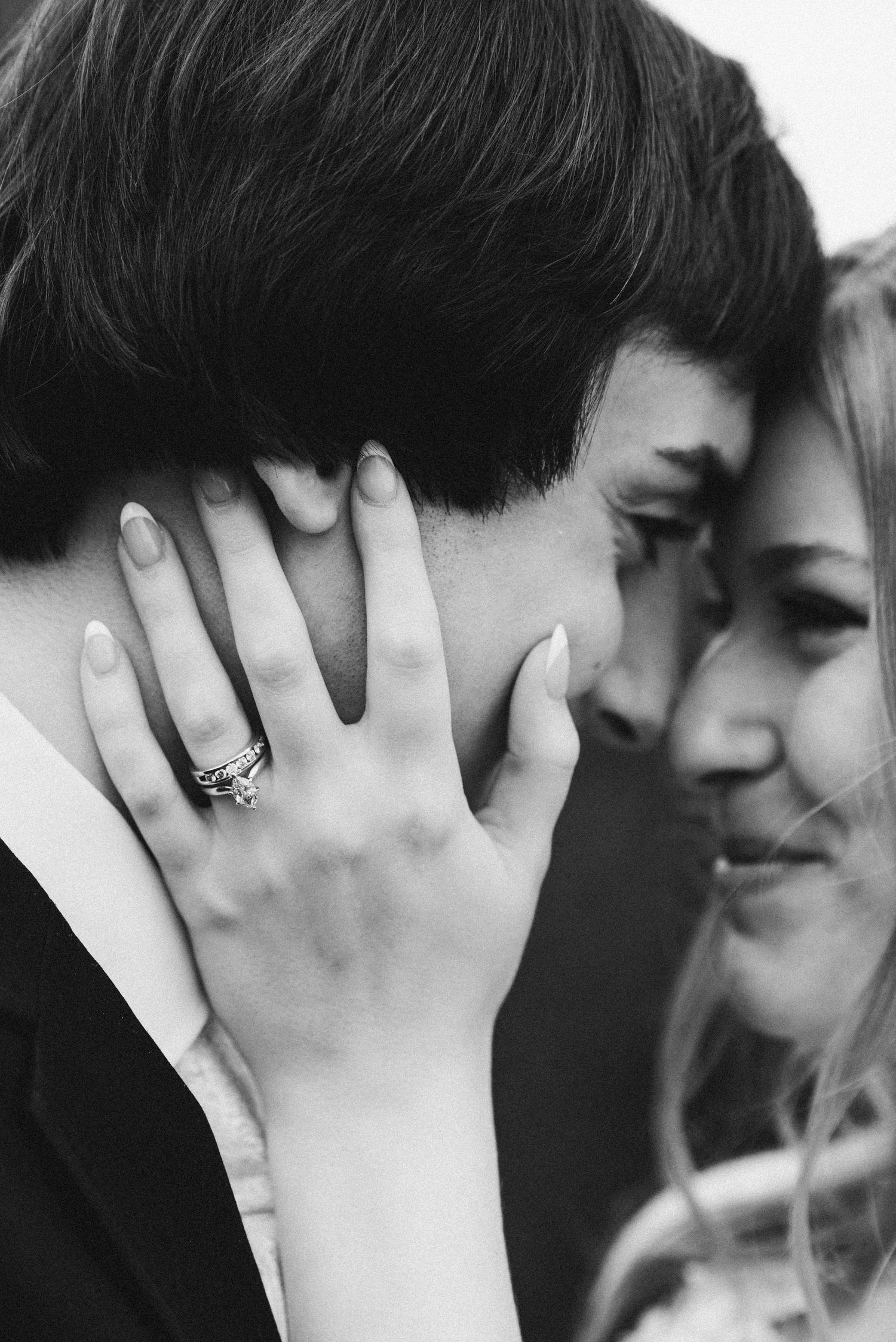 Mr. and Mrs. McDuffee share a smile while resting their foreheads on each other as the bride caresses the groom's cheek.