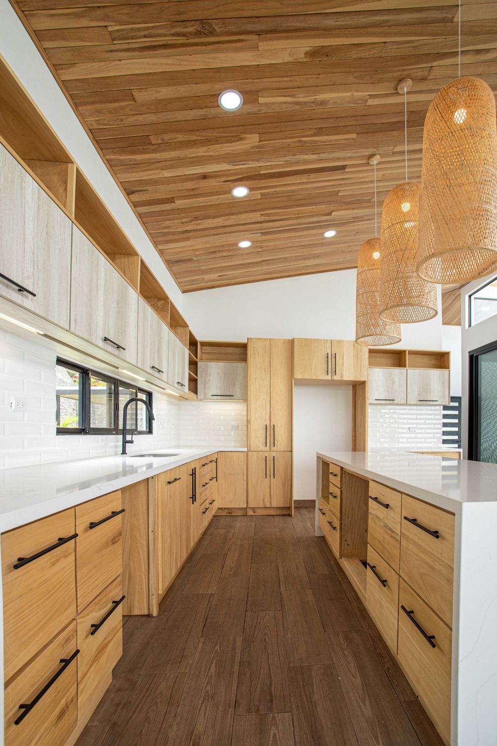 Contemporary kitchen with wooden finishes, integrated lighting, and functional design, perfect for modern living in Atenas, Costa Rica