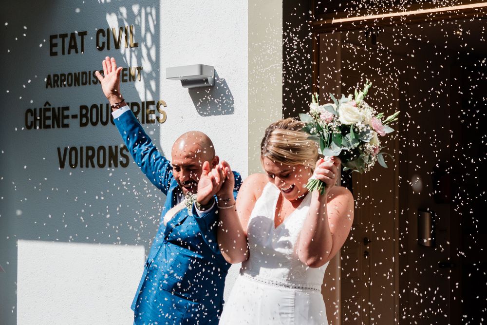 Bride and groom exit the Etat civil Chêne-Bougeries- Voirons and are showered with rice confetti in Geneva, Switzerland