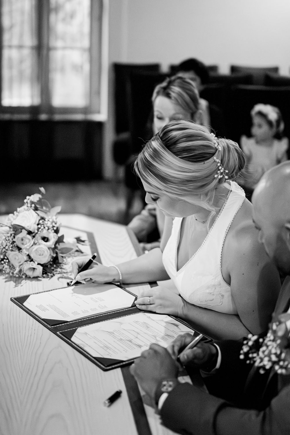 Bride signing the wedding papers at her civil ceremony