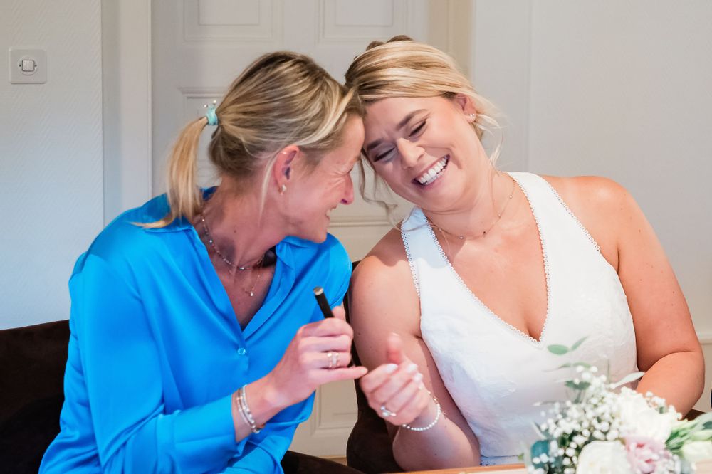 bride and best friend doing a pinky promise just before the ceremony in Geneva, Switzerland
