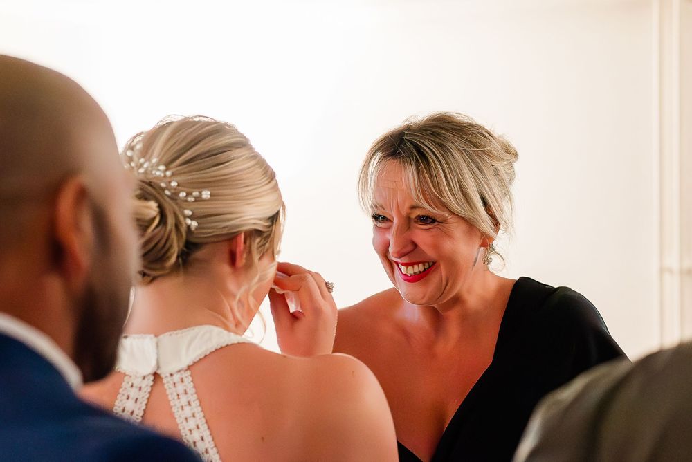 tearful emotions captured by the bride and the mother of the bride after the wedding ceremony