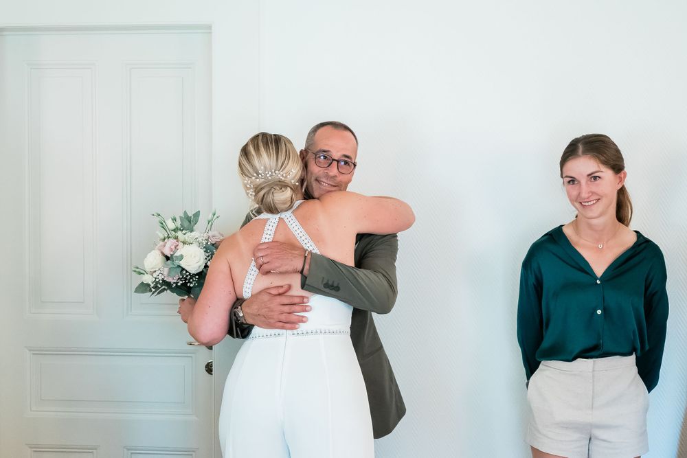 bride hugs her dad after the ceremony in loving affection