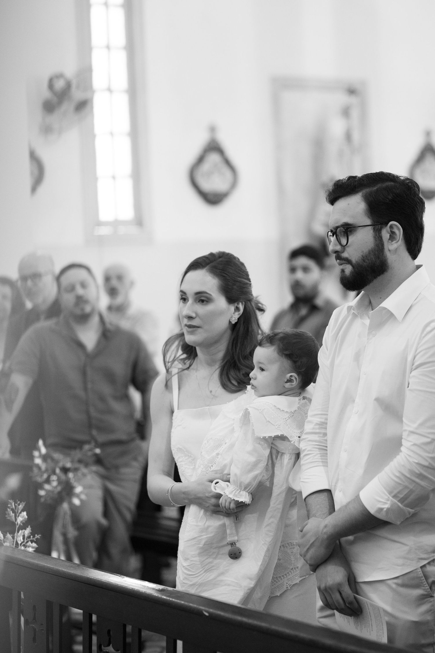 A gathering of people during a religious ceremony in a bright church interior.