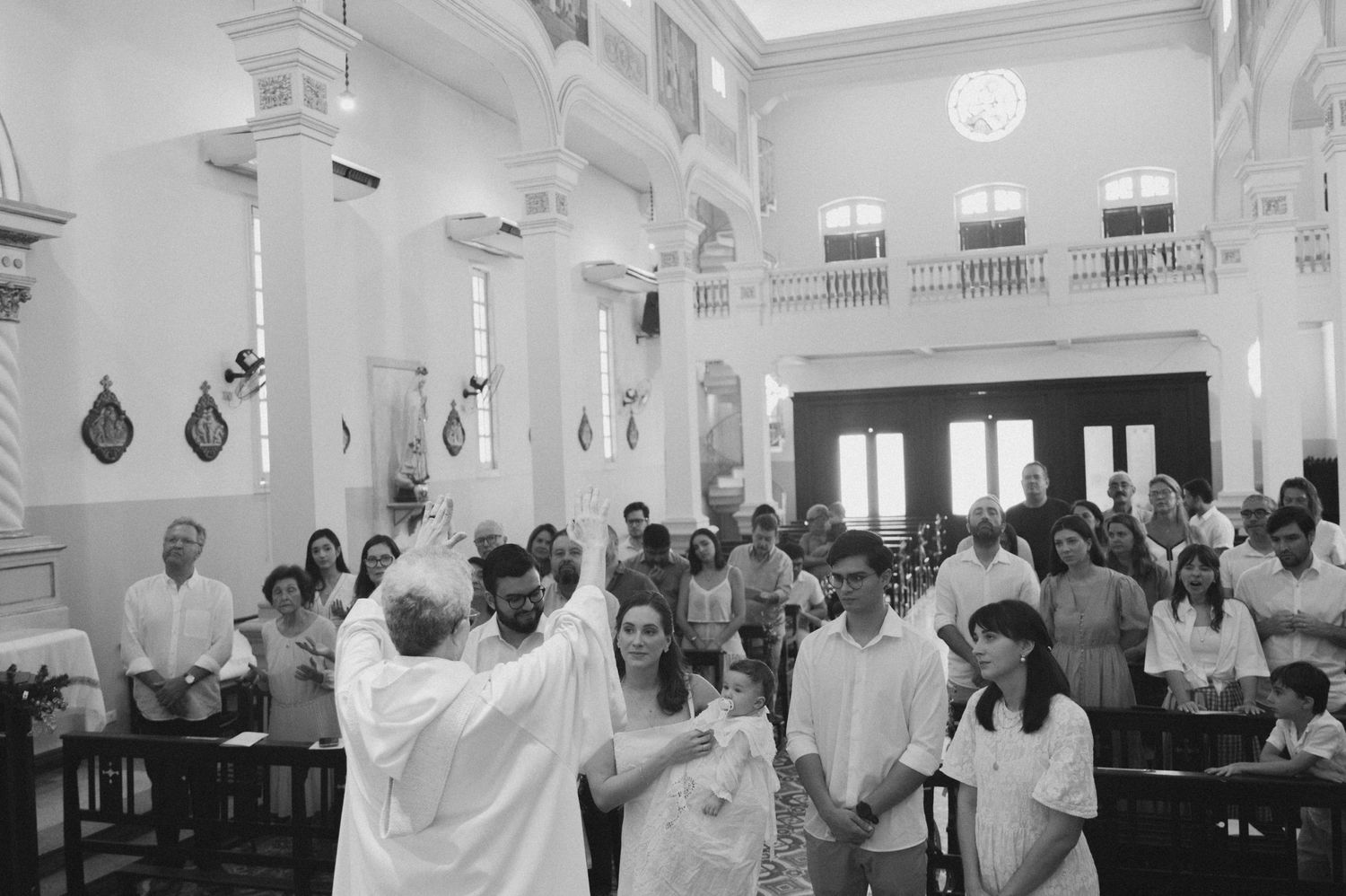 Black and white photograph of a religious ceremony with congregation in a grand church interior.
