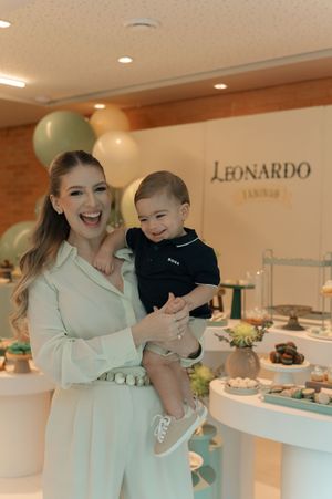 A series of connected photos showing someone in a white sweater holding and playing with a baby in an elegant interior space.