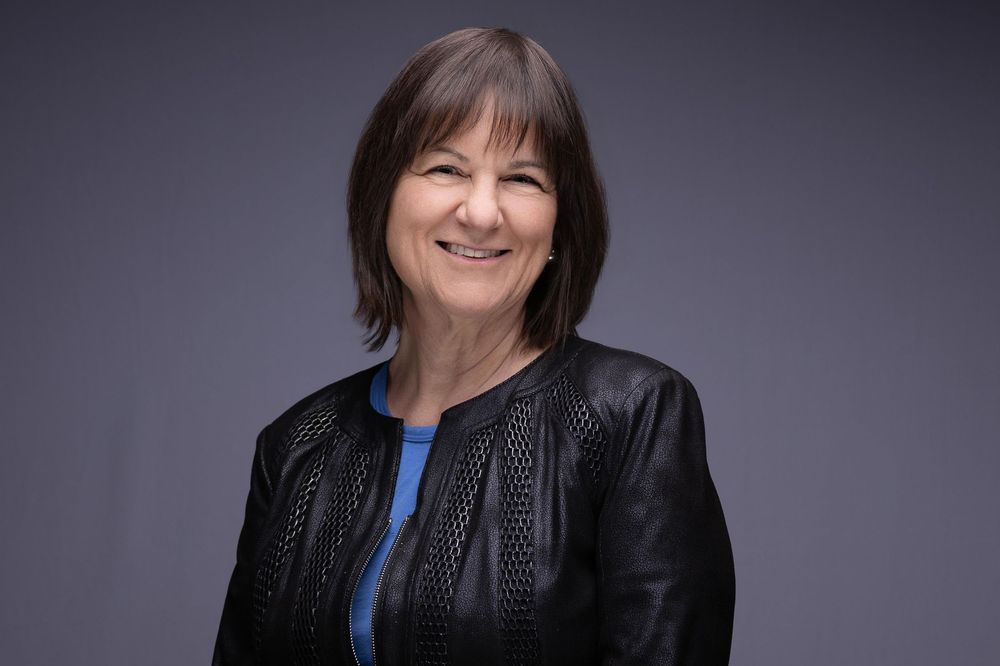 Corporate Headshot of a smiling woman in a black leather Jacket | Montclair headshot photographer