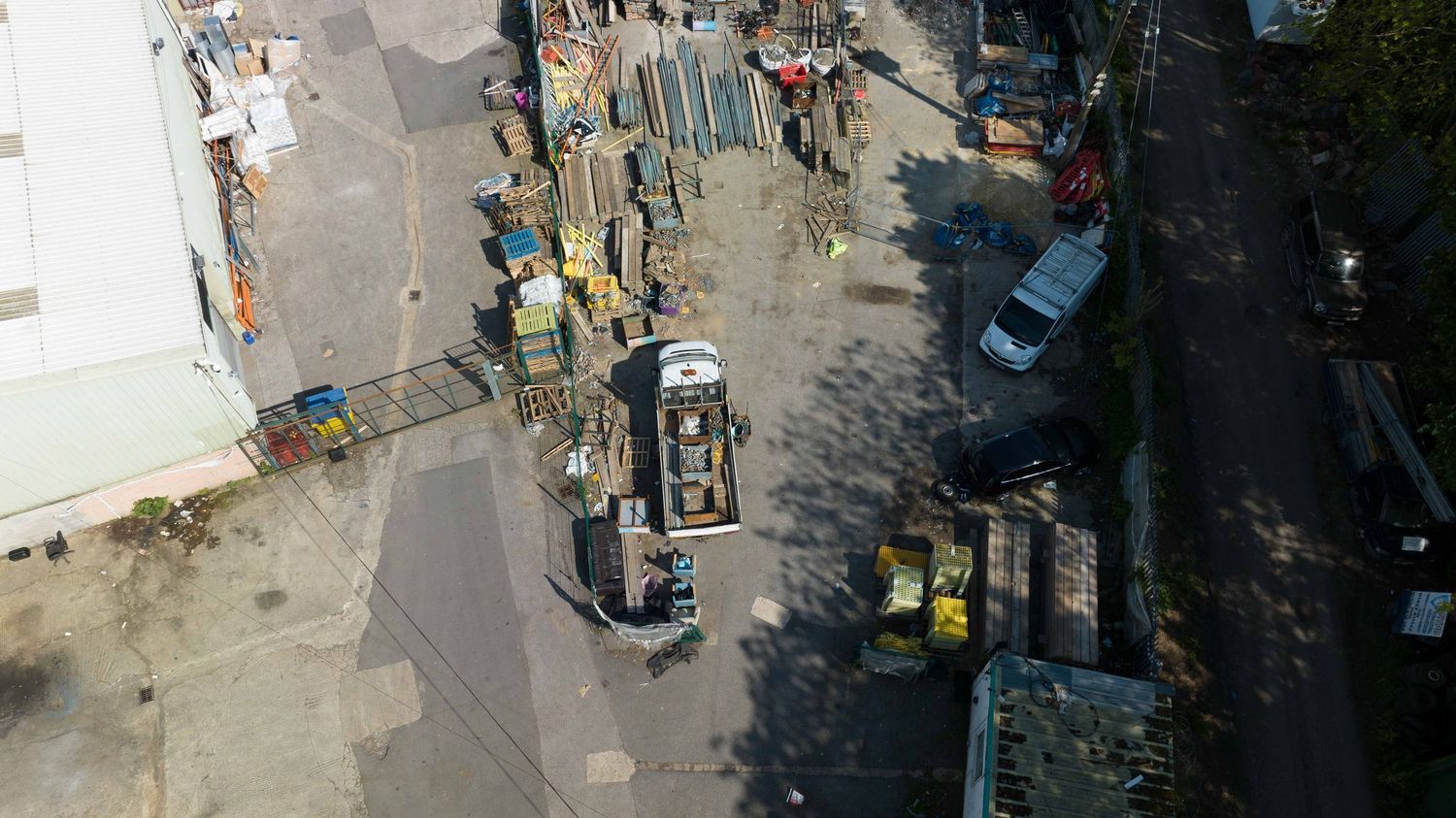 Aerial view of construction site with heavy machinery and vehicles working on urban development project in daylight.