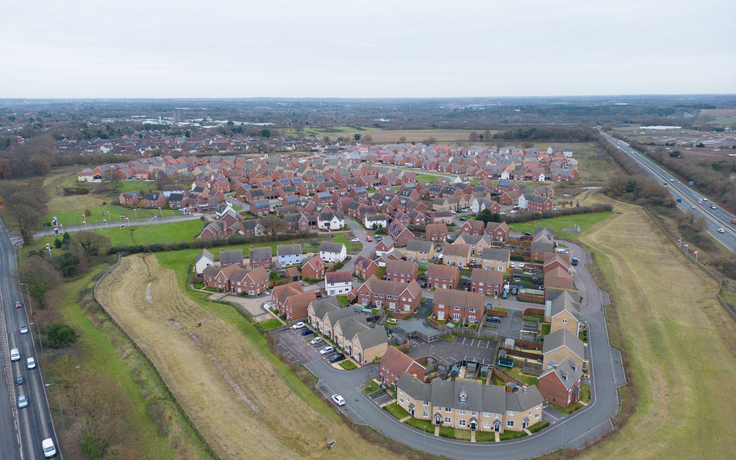 Aerial panoramic drone photo showing multiple residential neighborhoods and surrounding farmland in a suburban setting.