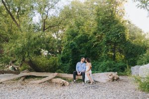 Natural shoreline with trees and rocks creates peaceful lakeside setting.