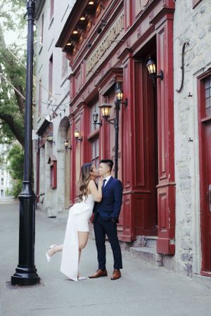 Historic building facade with red trim and lanterns creates an elegant urban setting.