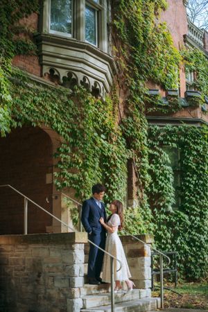 Ivy-covered stone walls and white columns create a romantic architectural backdrop.