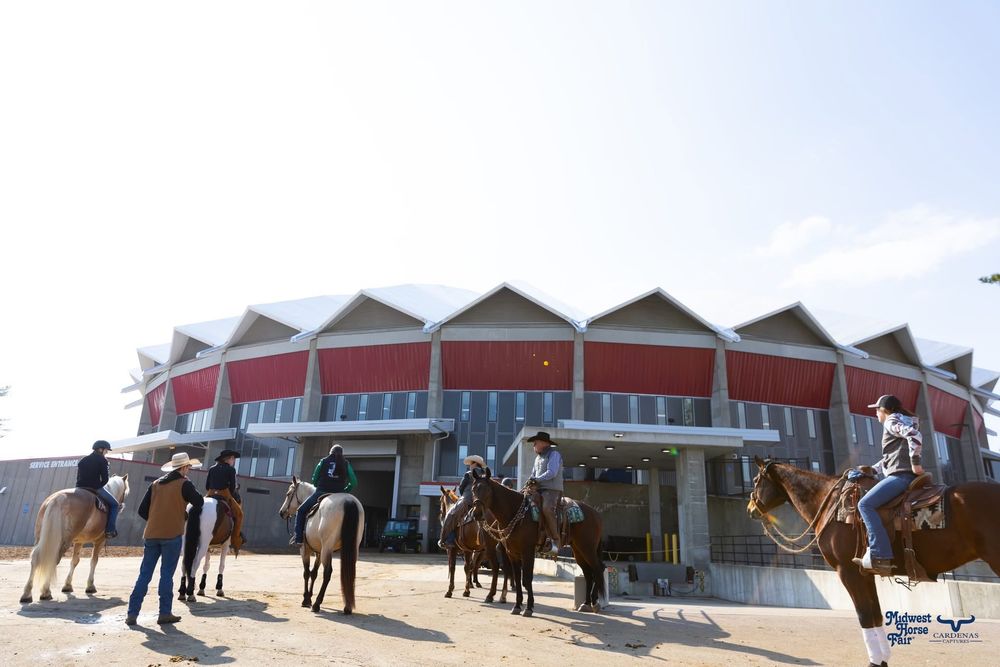 Exterior view of a large equestrian center with horse trailers and spectators. Wisconsin Pro Rodeo PRCA Rodeo Photographer Dakota Cardenas