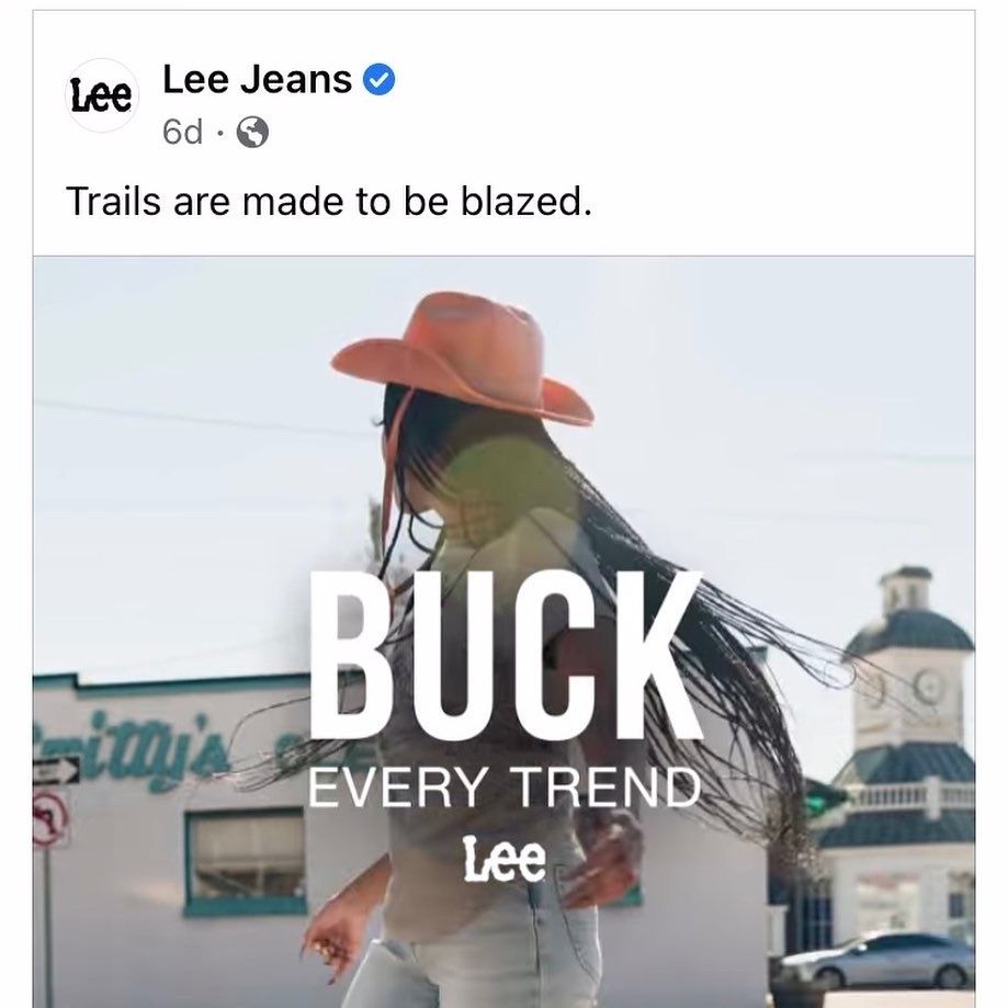 Advertisement for Lee Jeans showing person in denim and cowboy hat with text 'Buck Every Trend' overlaid on image.