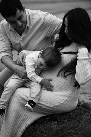 Pregnant mother cuddling with her first child during a quiet family moment