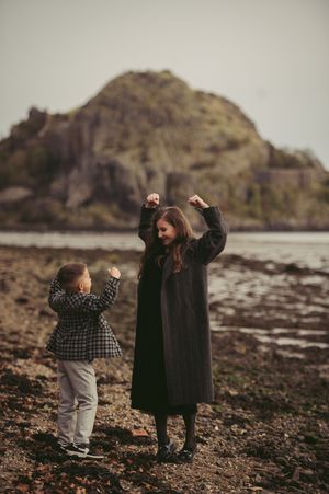 Editorial-style image of a mother and son walking hand in hand