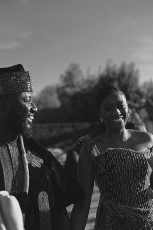 A black and white photo showing two people sharing a joyful moment outdoors.