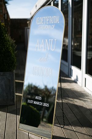Three modern blue signage panels mounted on a white wall with angled shadows and reflective surfaces.