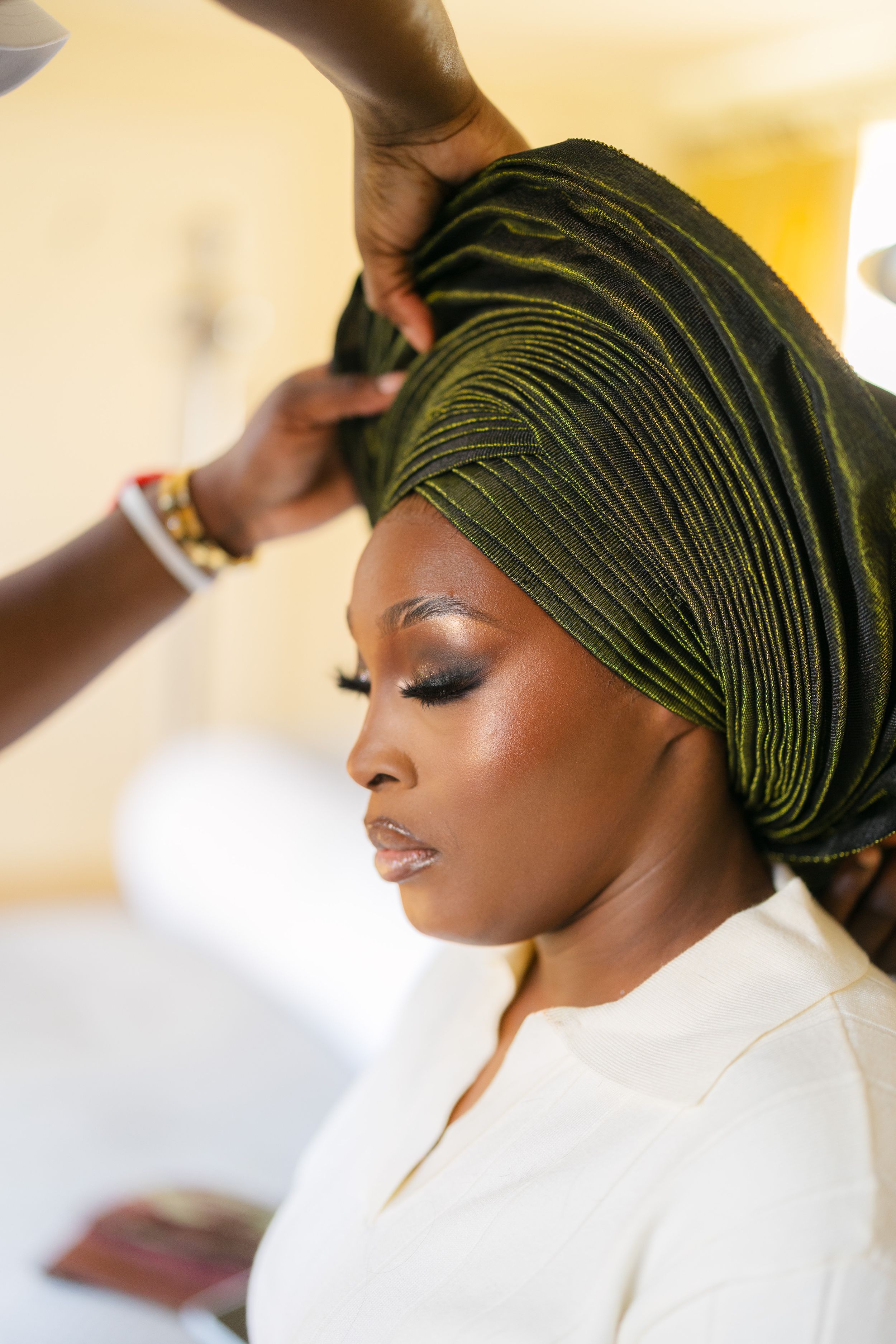 A series of profile photos showing a bold green headwrap with elegant makeup and styling.