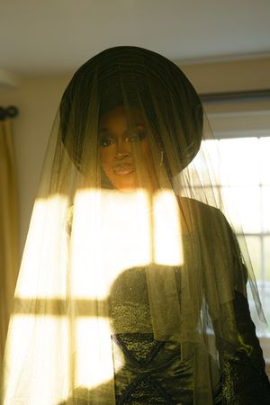Five connecting photos show silhouettes of figures through sheer curtains with warm natural sunlight streaming in from behind.