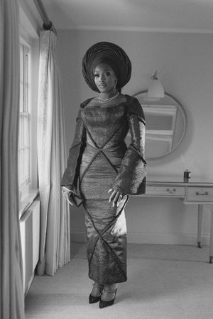 Vintage black and white fashion photograph showing four sequential views of a woman modeling a 1950s dress and hat.