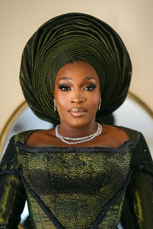 A series of fashion portraits featuring a figure in a black gown and elegant dark headwrap adorned with a crystal necklace.