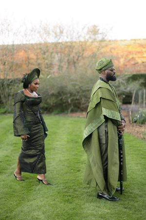 Person wearing a green cape strikes dynamic poses in a grassy outdoor setting.