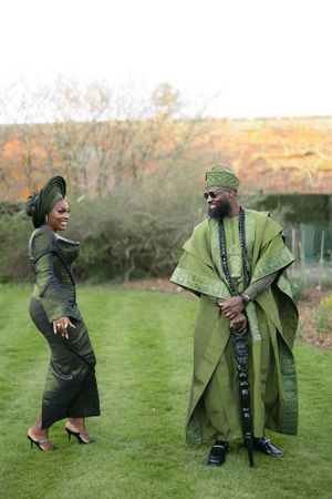 Traditional African fashion photoshoot featuring coordinated green formal wear on a lawn.