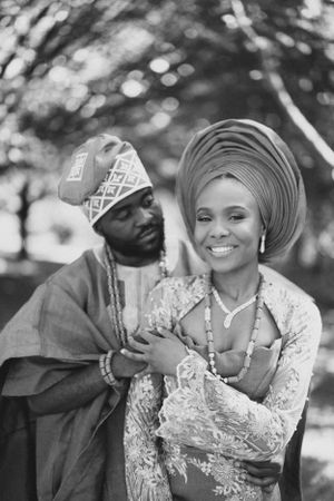 Black and white portrait of a couple in traditional Nigerian wedding attire.