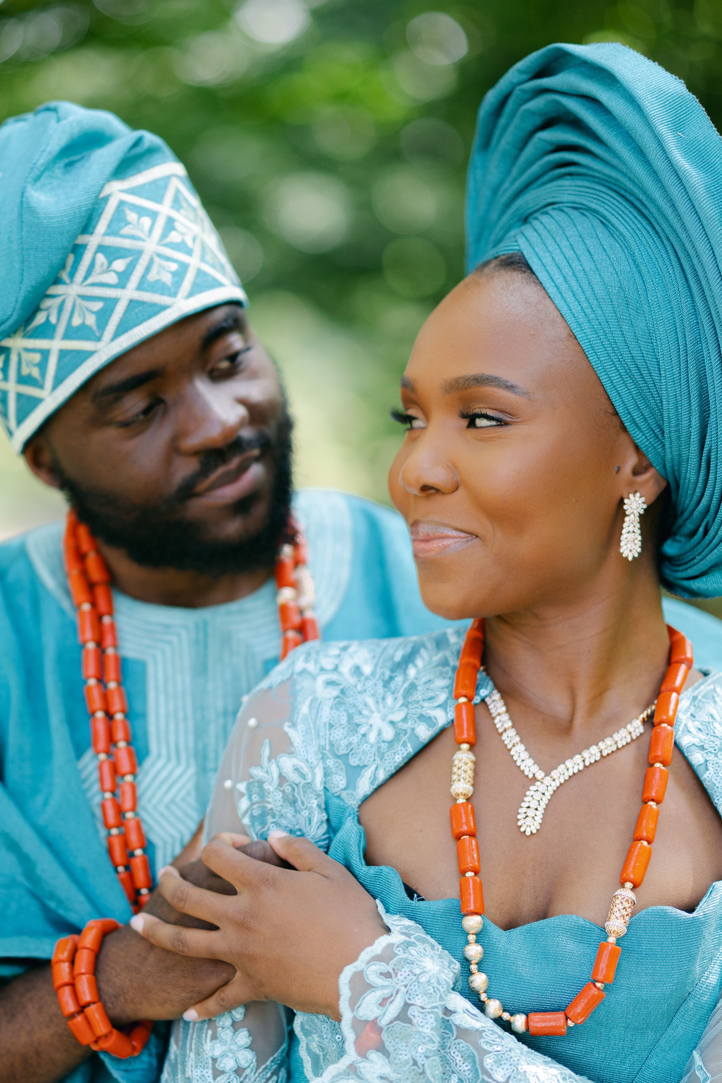 Intimate portrait of couple in matching teal traditional African formal wear.