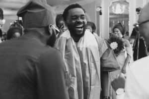 Black and white vintage photograph showing joyful celebration at social gathering.