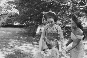 Vintage black and white photograph showing three women in traditional African dress.