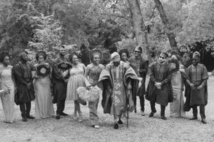 Vintage black and white photograph of large group in traditional African ceremonial dress.