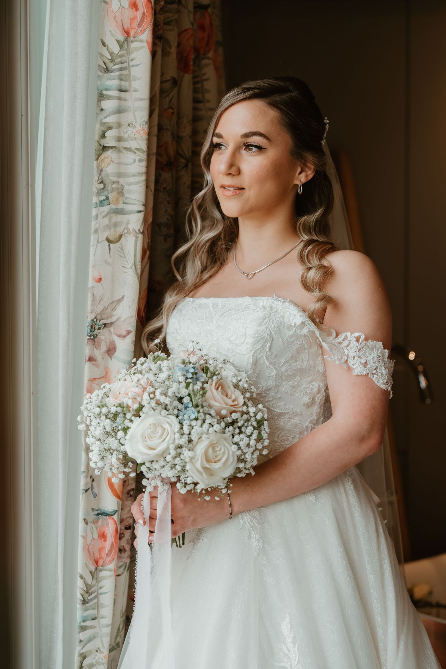 Three elegant bridal portraits showcase a white lace off-shoulder wedding gown and delicate bouquet of roses and baby's breath.