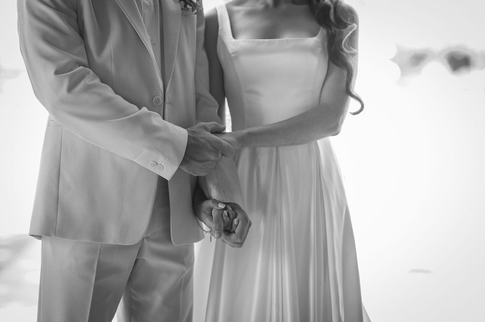 A black and white capture of a couple's intimate wedding moment.