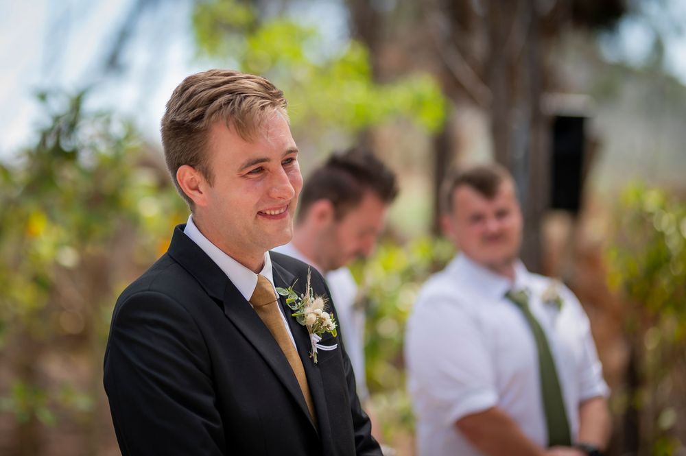 A joyful expression during an outdoor wedding ceremony.