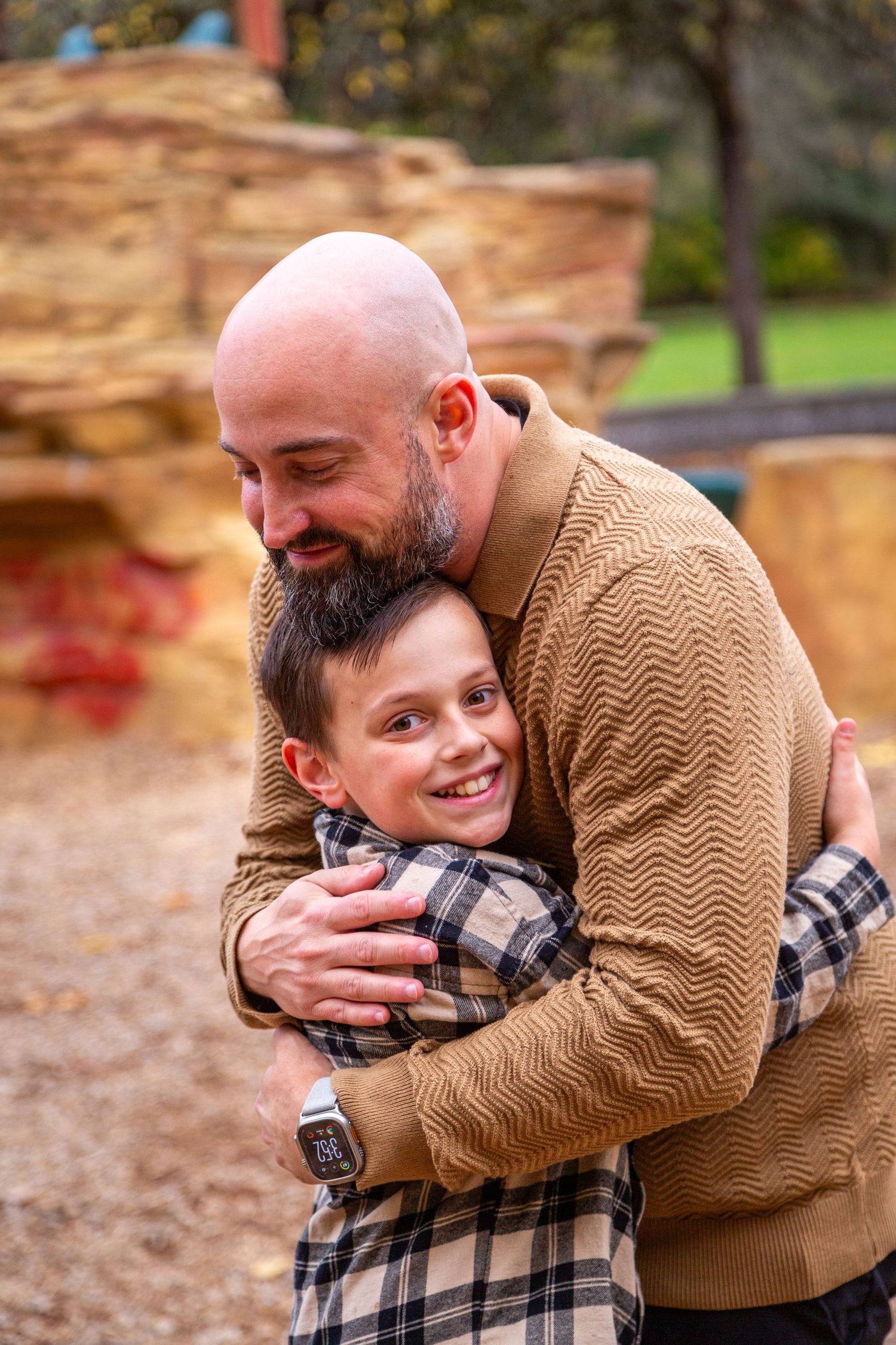 A loving moment captured between parent and child sharing warm embraces in an autumn outdoor setting.