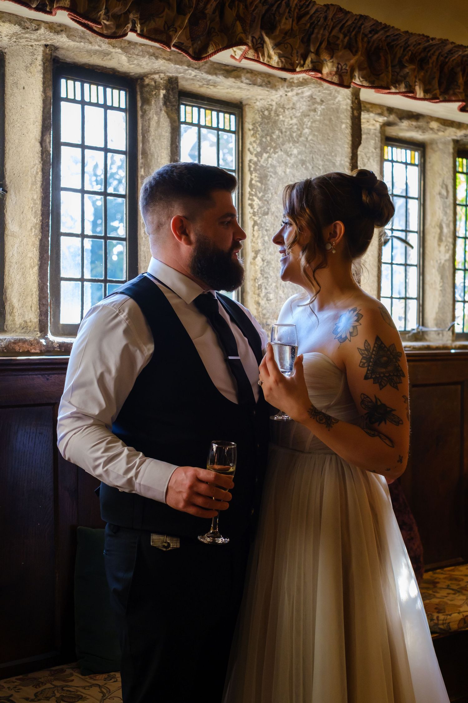 Alice and George sharing quiet moment besides the lovely stone mullion windows.