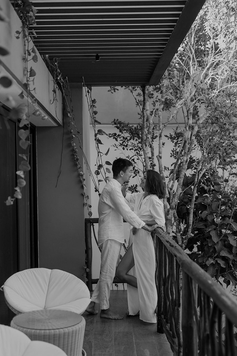 Couple on balcony surrounded by greenery during Nativus Tulum elopement Riviera Maya wedding photography.