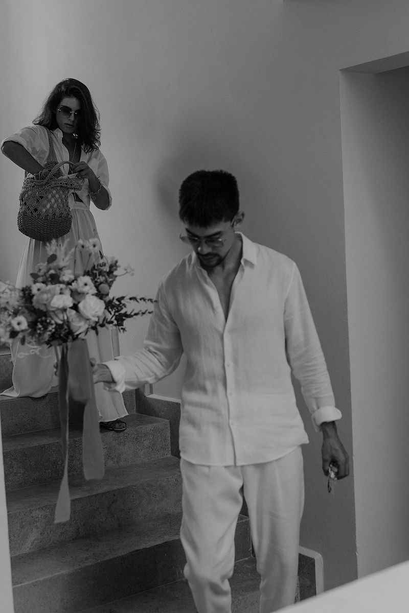 Bride walking downstairs in white dress during Tulum elopement Riviera Maya wedding photographer.