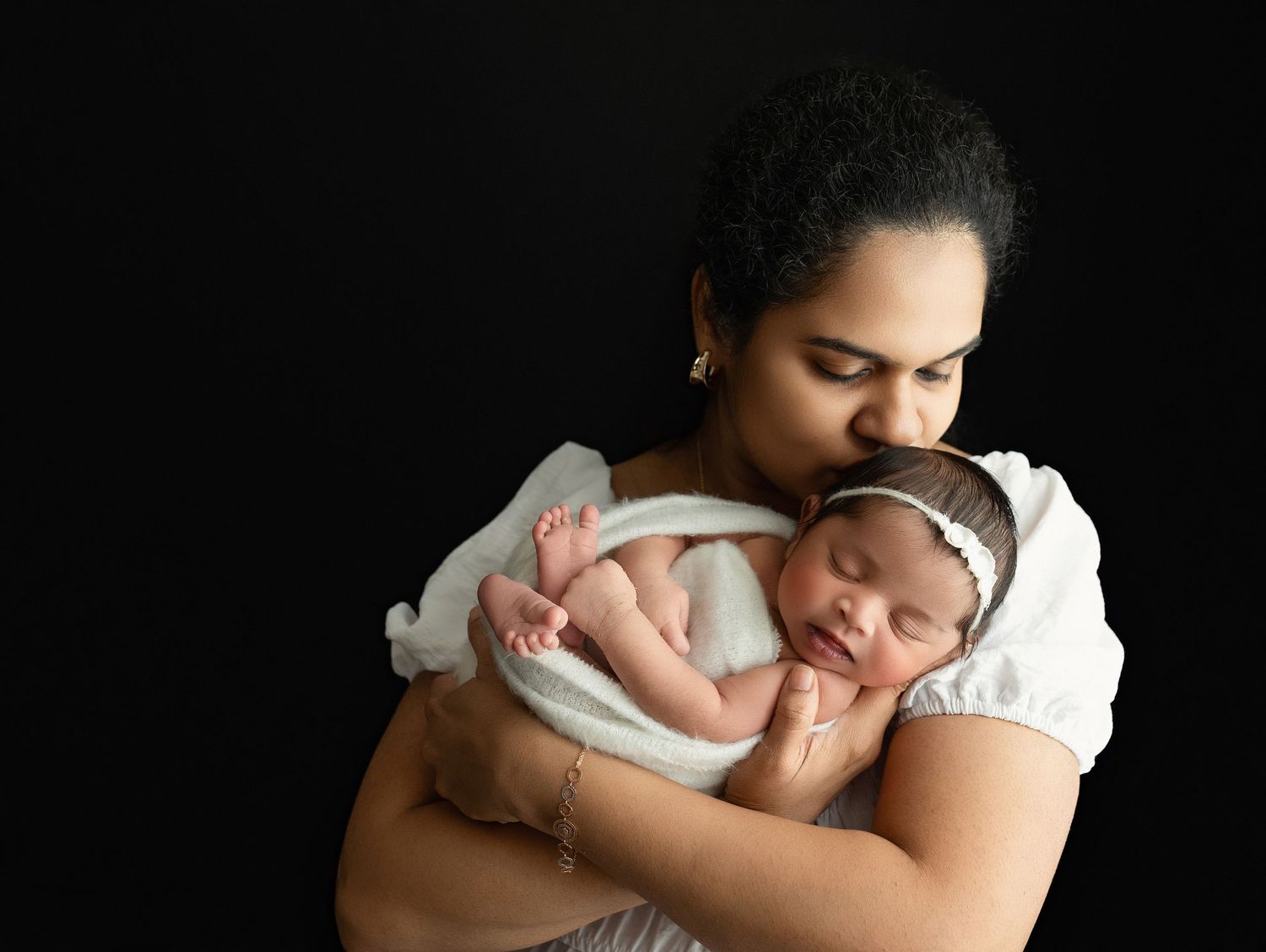 An Indian Mother holding their newborn. Greenville SC newborn photographer, Easley, SC newborn photographer