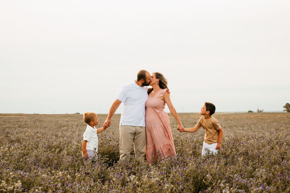 Group standing together in a golden field at sunset.