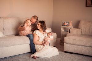 A series of tender family moments captured in warm tones as they cuddle together on a light-colored couch.