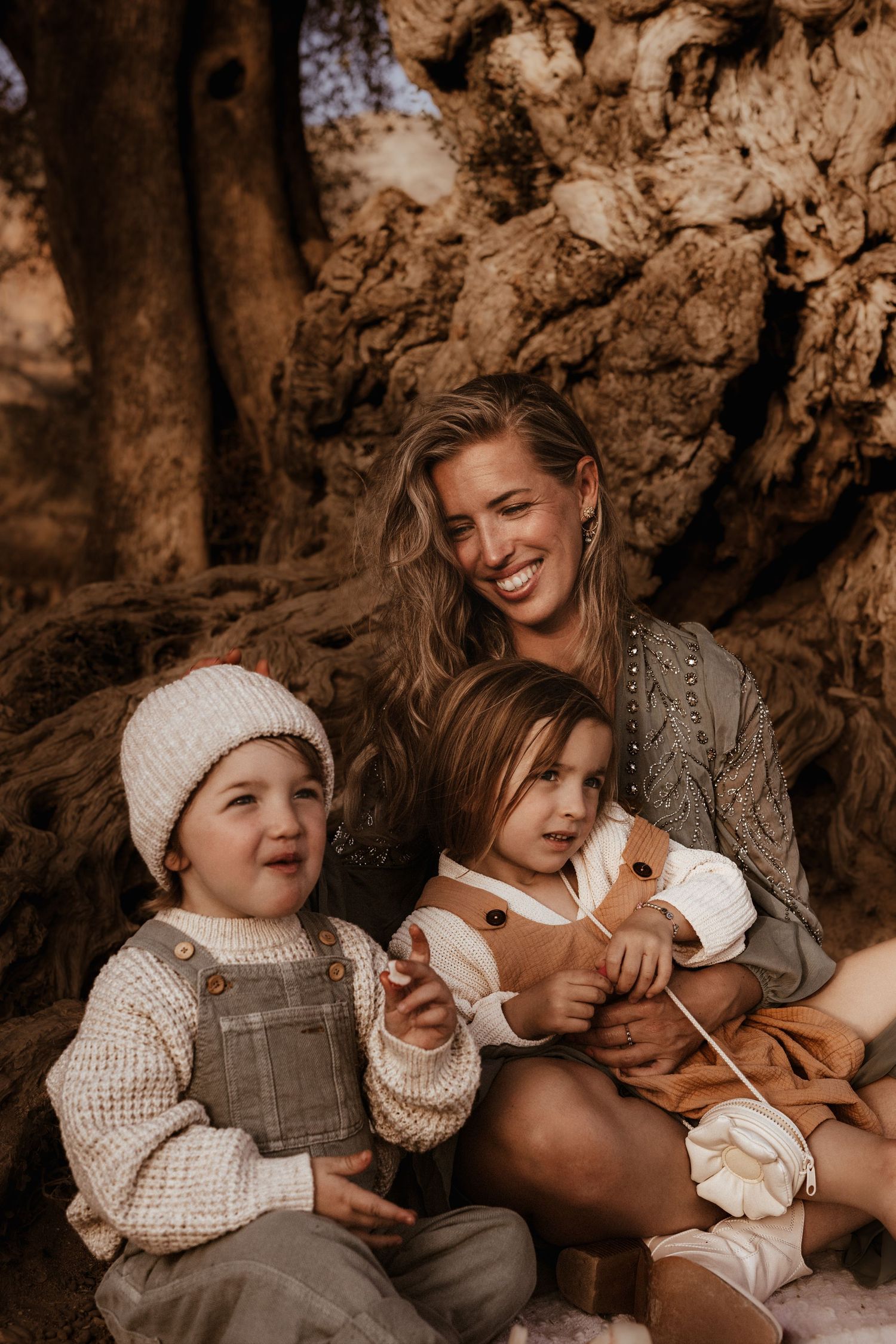 A warm-toned outdoor family portrait in Denia  shows a sweet moment together - Denia family photographer