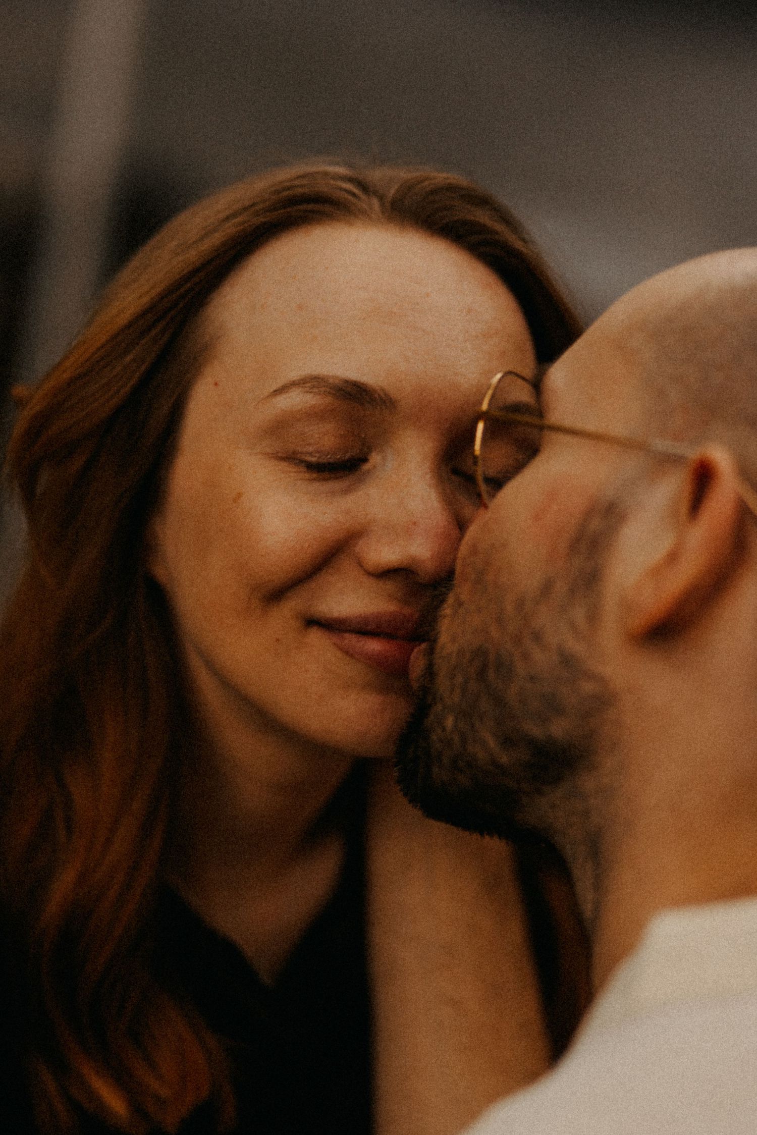 A tender intimate moment captured in warm lighting between two people.