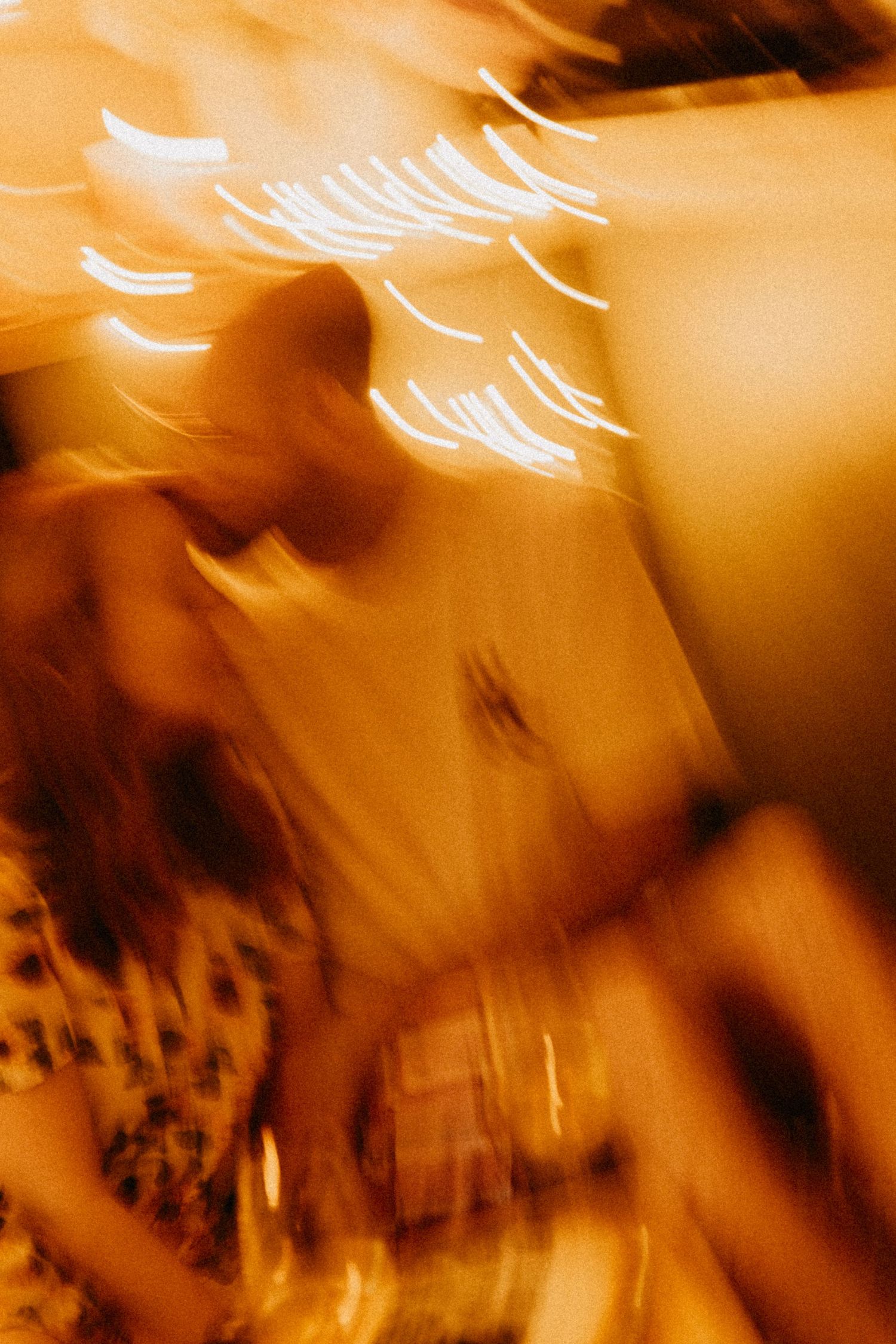 Abstract blurred motion photograph with streaks of light in warm amber tones.