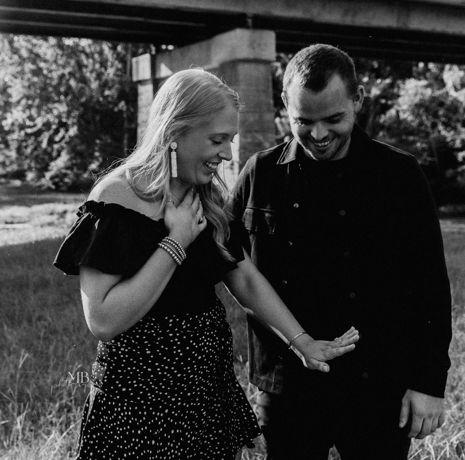 Couple laughing together during casual outdoor photoshoot.